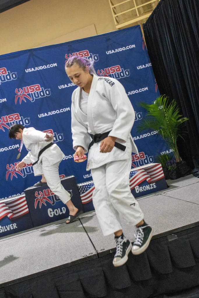 Kaiya Johnston hops down from the awards area after winning her bronze medal in the senior division.