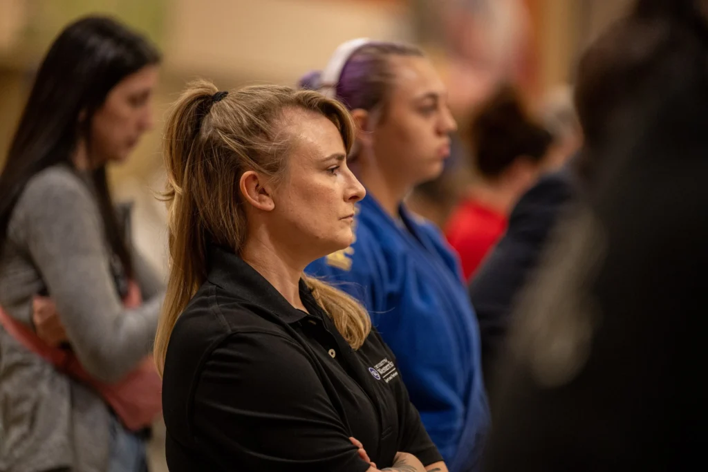 MASTERS Mental Performance Coach Erin Herle watches matches while waiting for Kaiya Johnston to compete.