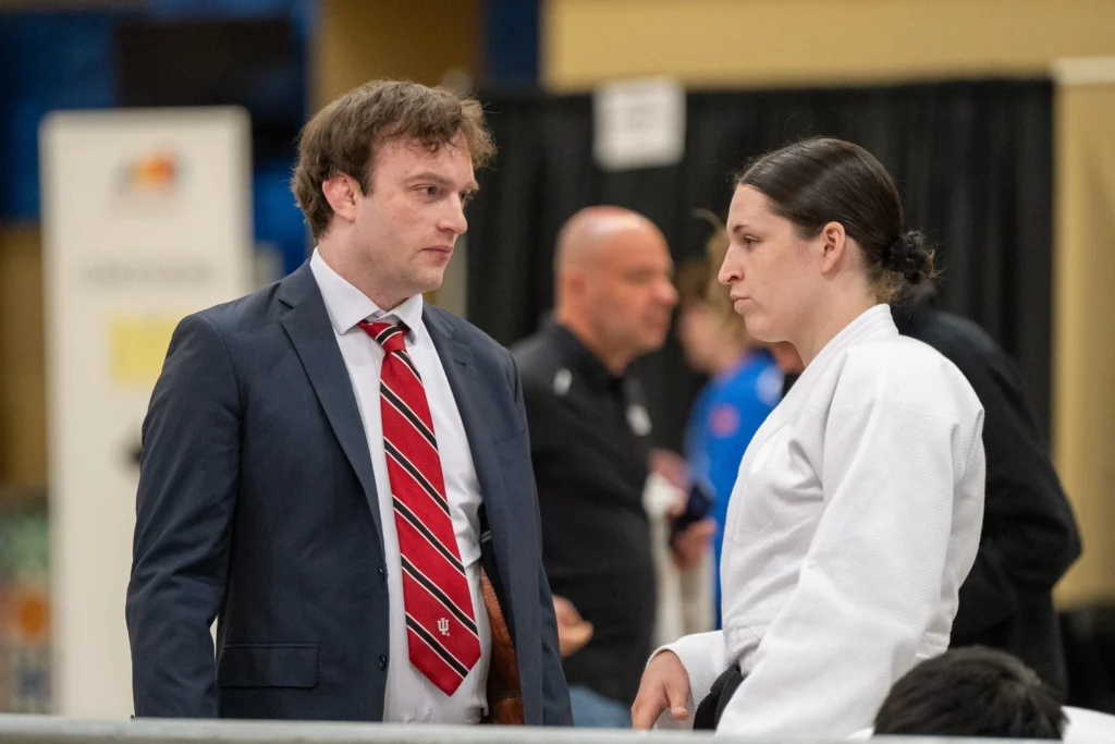 Head Coach Dr. Christopher Round conferring with fellow Chloe Williams during the senior division.
