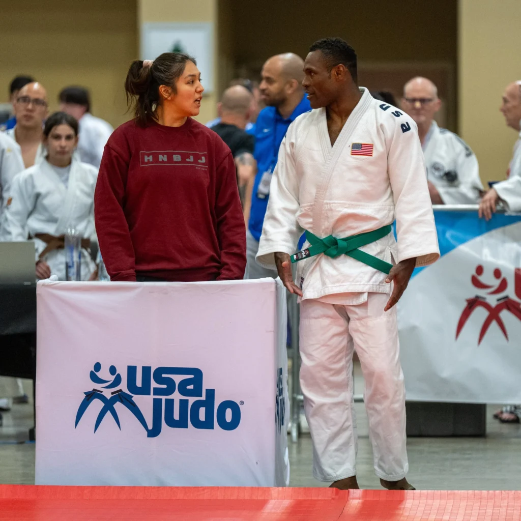 MASTERs Athlete Madeline Solis is recovering from an injury and came to nationals to coach. She is pictured here working with High Noon owner Tim Dawson before one of his matches.